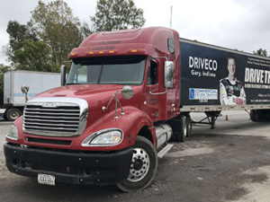 a red semi truck sponsored by the national guard