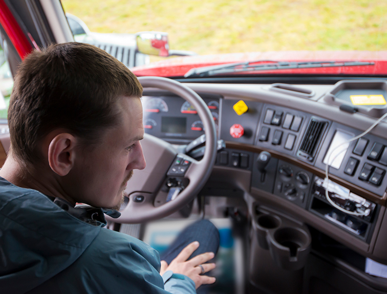 man sitting in driver seat of truck