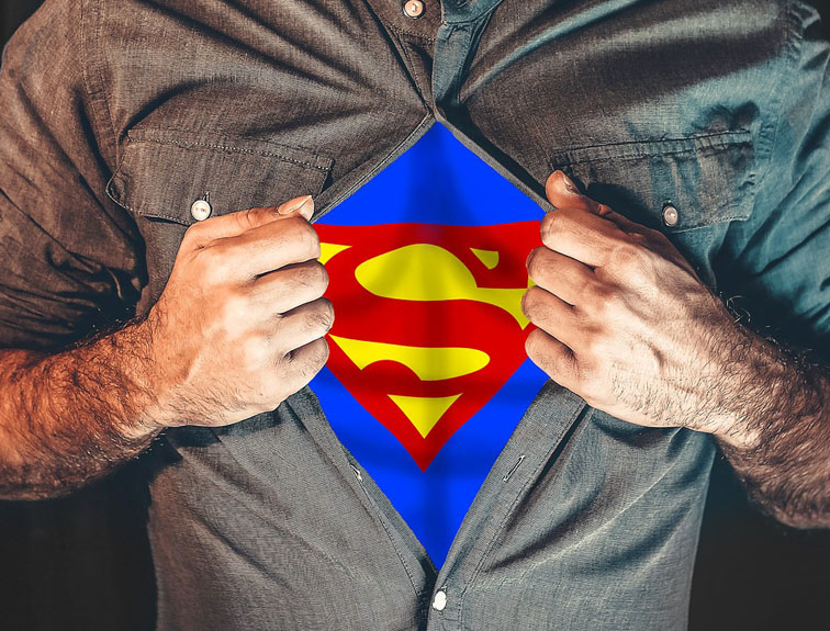 Image of man opening button-up shirt to show superman suit underneath