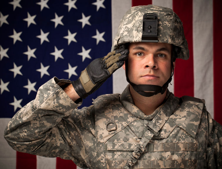 image of Military soldier with American flag in background.