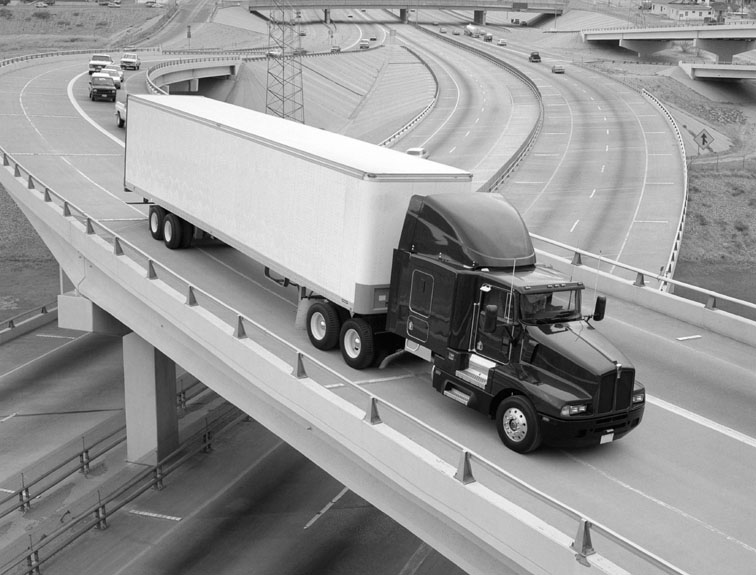 image of semi driving down the highway in black and white
