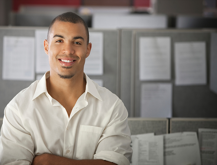 image of man standing in offer with arms crossed