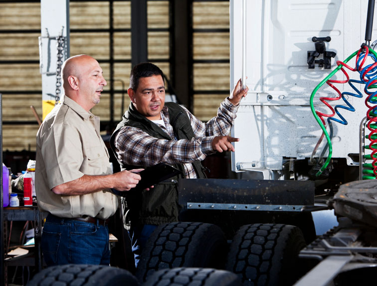 image of student and teacher working on truck maintenance