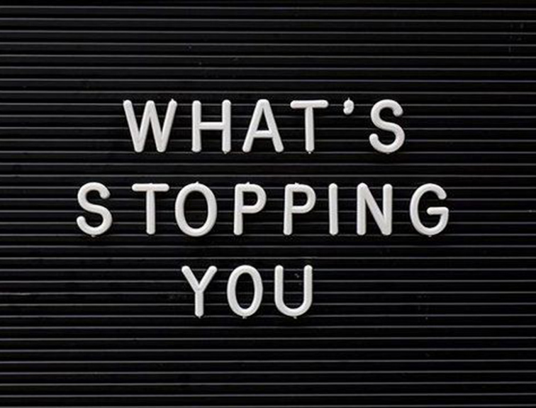 image of black letter board, white "what's stopping you" text in center