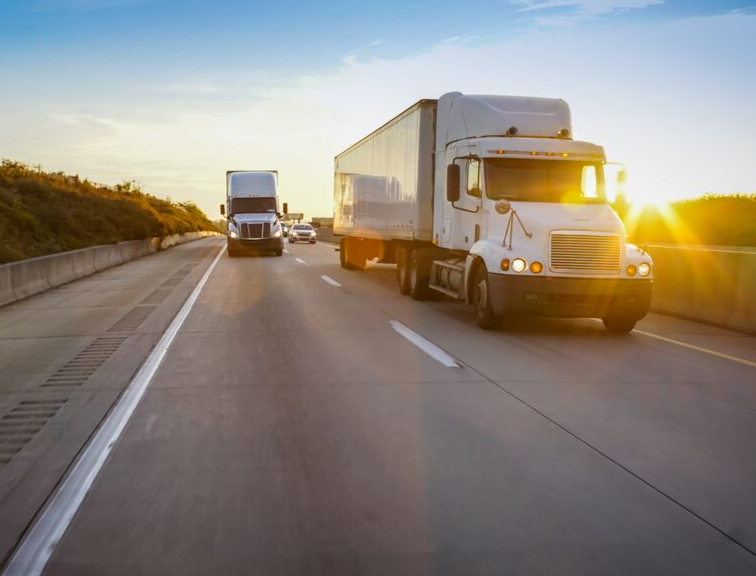 image of two trucks on highway driving near each other